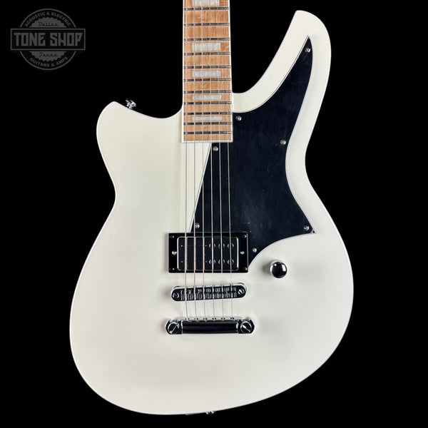White electric guitar with a black pickguard on a black background, featuring 'Tone Shop' branding.