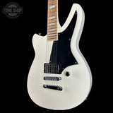 White electric guitar with a black pickguard on a black background, featuring 'Tone Shop' branding.