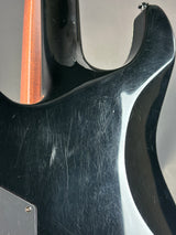Close-up of a guitar with visible wear and tear on the body