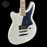 White electric guitar with a black pickguard on a black background, featuring 'Tone Shop' branding.