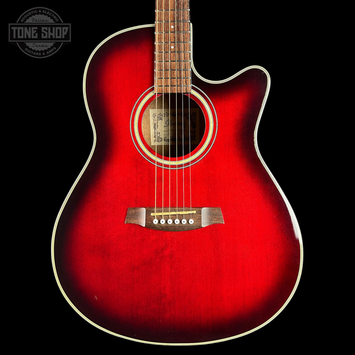 A red acoustic-electric guitar with a cutaway body, shown from the front against a black background. The brand name 'Tone Shop' is visible as a watermark in the top-left corner.