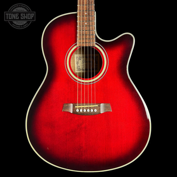 A red acoustic-electric guitar with a cutaway body, shown from the front against a black background. The brand name 'Tone Shop' is visible as a watermark in the top-left corner.