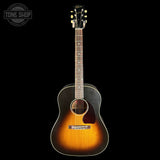 Acoustic guitar with a sunburst finish on a black background, featuring the Tone Shop logo.