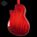 The back of a red electric guitar with a glossy cherry-red finish and white binding, shown against a solid black background. A Tone Shop watermark is visible in the top-left corner.