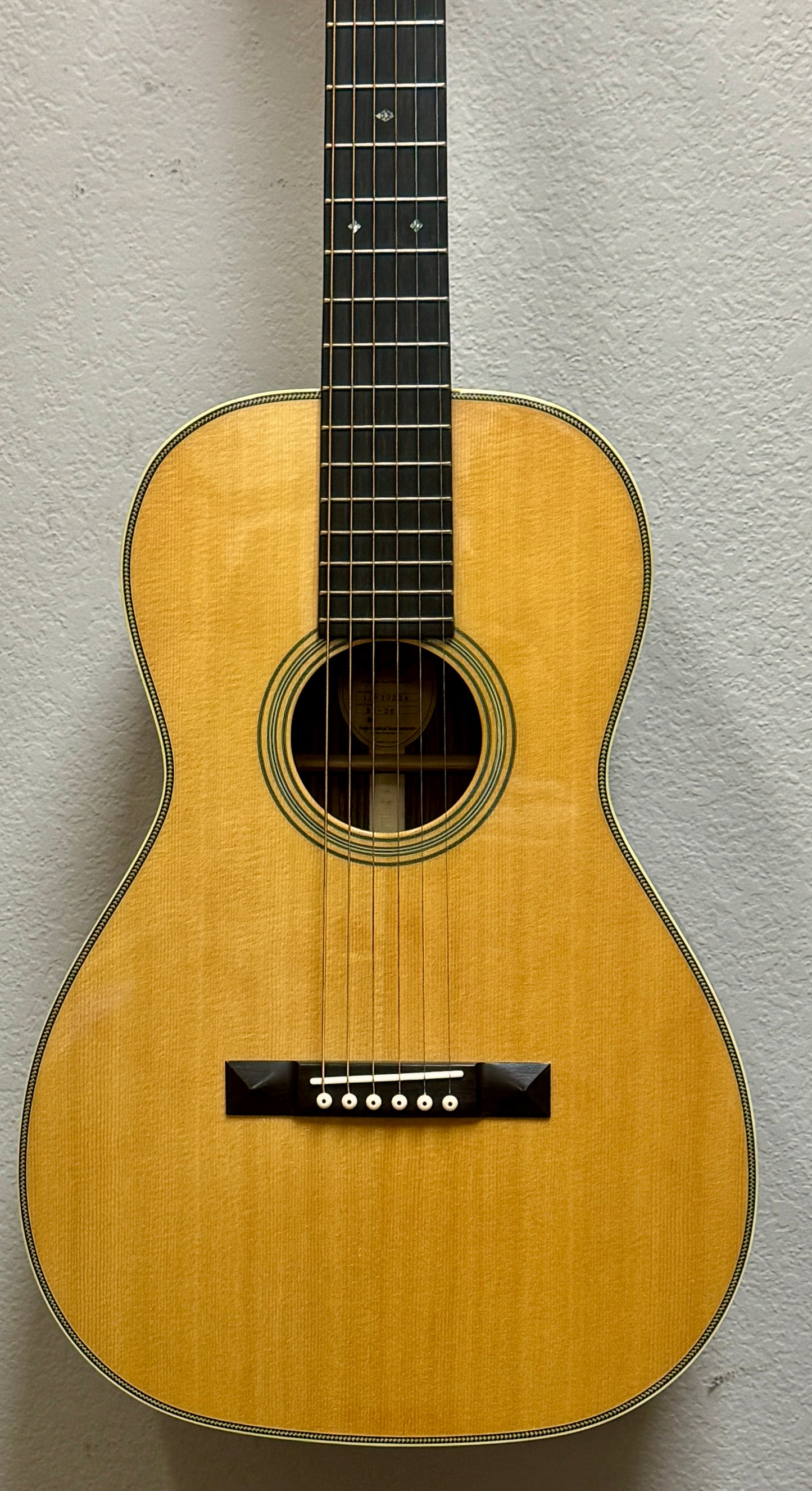 Acoustic guitar against a gray background