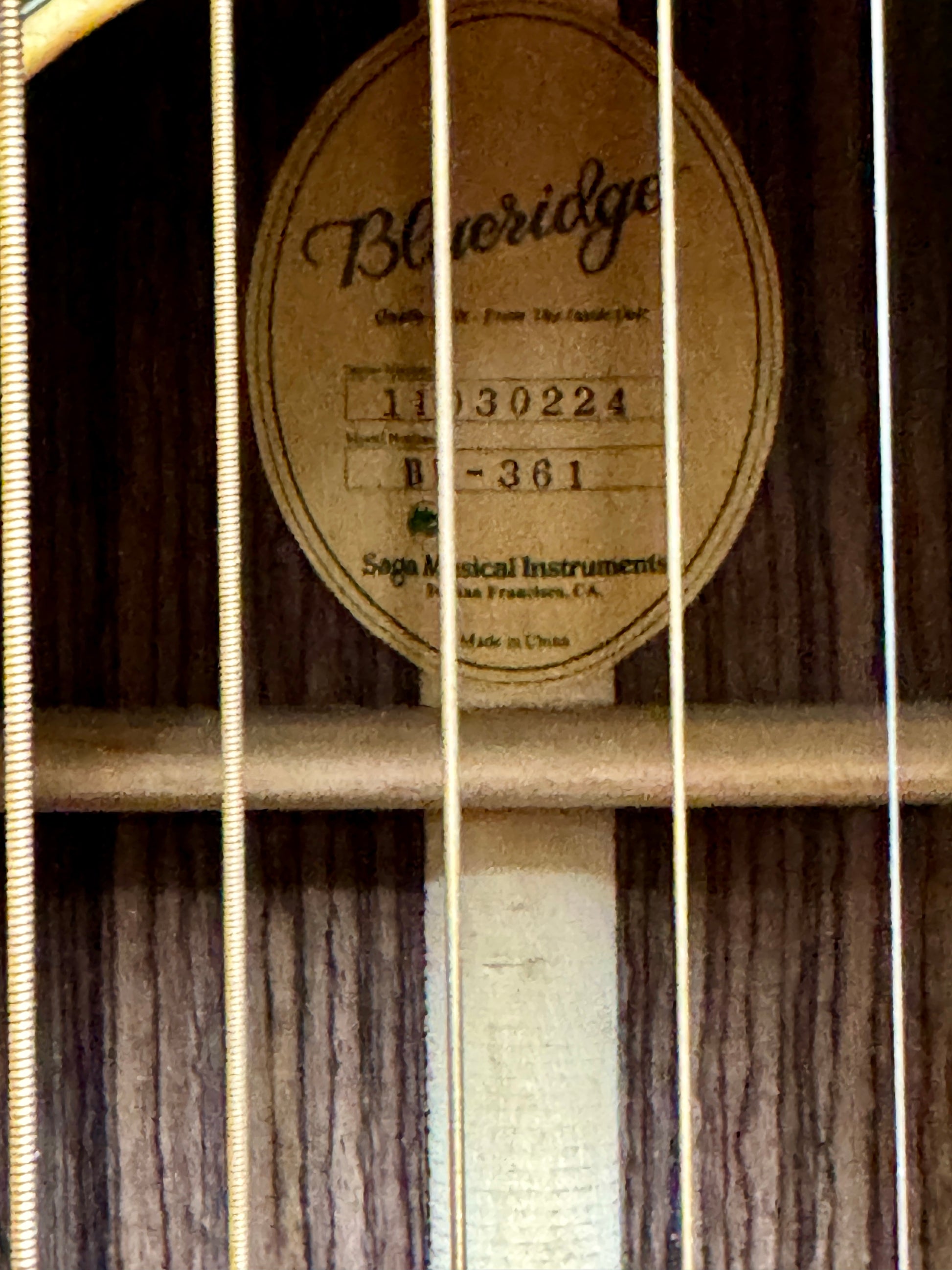 Close-up of a guitar label with 'Blue Ridge' branding and product details.