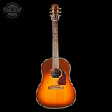 A classic acoustic guitar with a natural sunburst finish, shown vertically against a solid black background. The brand 'Tone Shop' is visible as a watermark in the top-left corner.