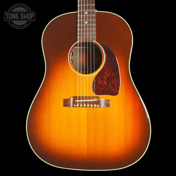 A classic acoustic guitar with a natural sunburst finish, shown from the front against a solid black background. The brand 'Tone Shop' is watermarked in the top-left corner.