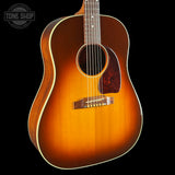 A classic acoustic guitar with a natural sunburst finish, shown against a solid black background. The brand logo 'TONE SHOP' is visible as an overlay in the top-left corner.