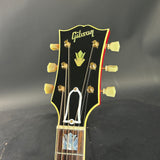 Gibson guitar headstock on a dark background