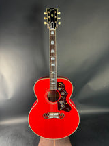 Red acoustic guitar on a dark gray background