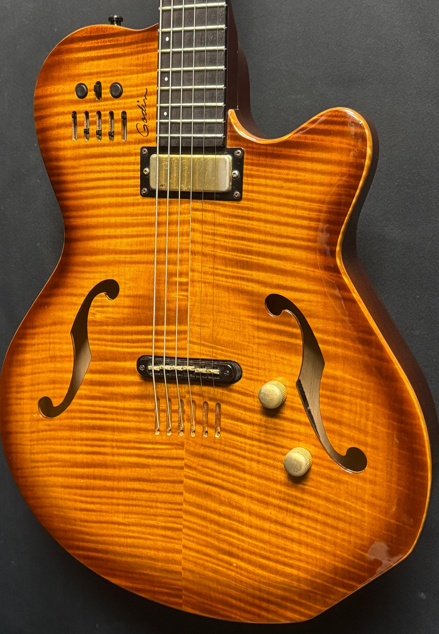 Wooden electric guitar with a dark background