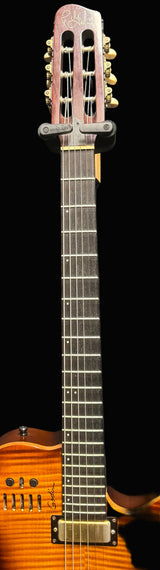 Classical guitar with a wooden body and metal strings against a dark background