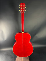 Red acoustic guitar on a dark gray background
