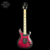 A double-cutaway electric guitar with a vibrant red and black flamed maple top, a light maple fretboard with black bird inlays, and black hardware, shown against a solid black background with a Tone Shop watermark in the top-left corner.
