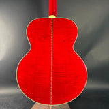 Red acoustic guitar on a black background
