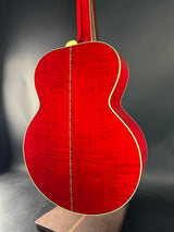 Red acoustic guitar body on a dark background