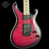 A double-cutaway electric guitar with a vibrant red and black flame finish, shown against a solid black background. The brand logo on the headstock is not visible, but the distinctive shape and hardware suggest a Paul Reed Smith (PRS) guitar.