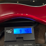 Used 2018 Fender Nate Mendel Precision Bass Candy Apple Red on scale displaying weight.