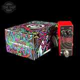 Guitar effects pedal with colorful packaging on a black background