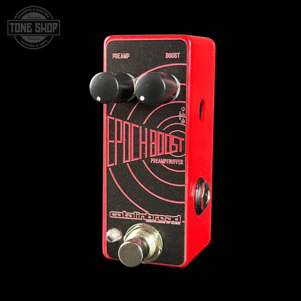 Guitar effects pedal with red and black design on a black background