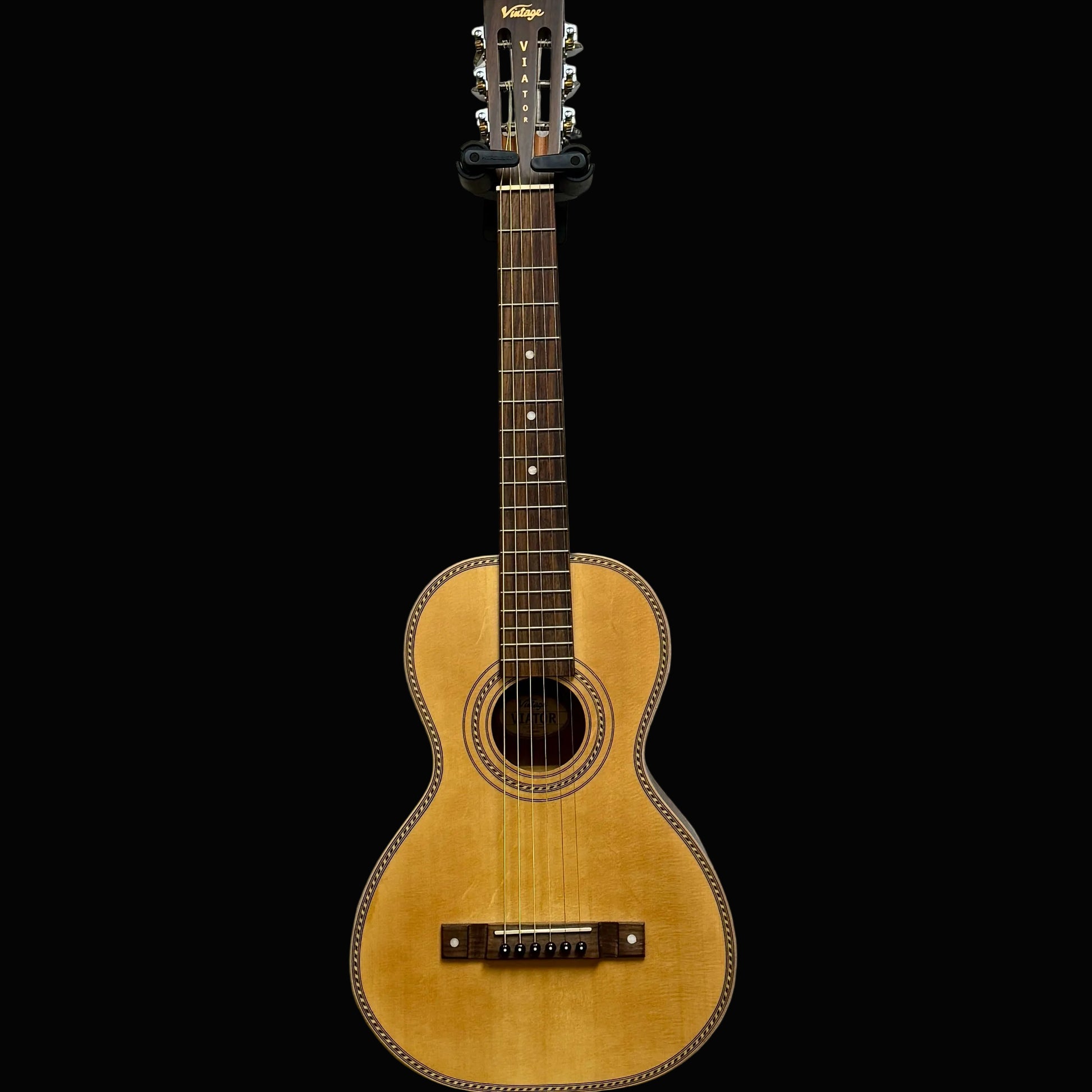 Acoustic guitar against a plain light gray wall