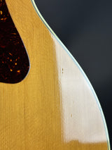 Close-up of a guitar's soundhole and wooden body