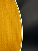 Close-up of a guitar's soundhole with a dark background