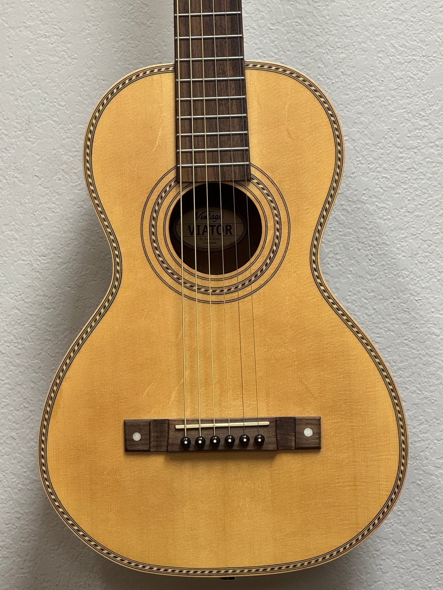 Acoustic guitar against a plain background
