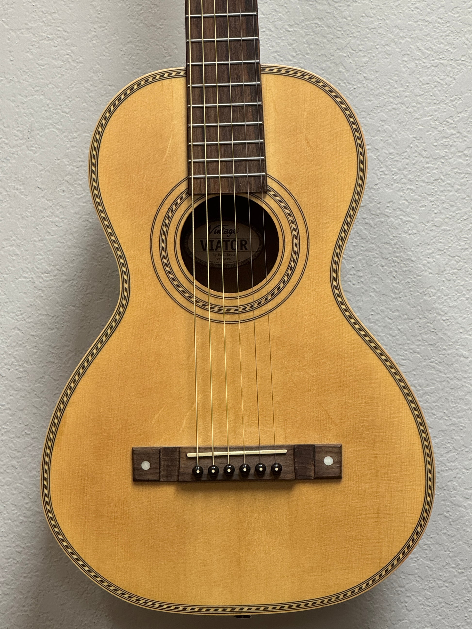 Acoustic guitar against a plain background