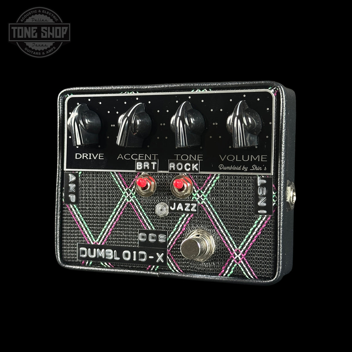 Guitar effects pedal with control knobs and switches on a black background, featuring the 'Tone Shop' logo.