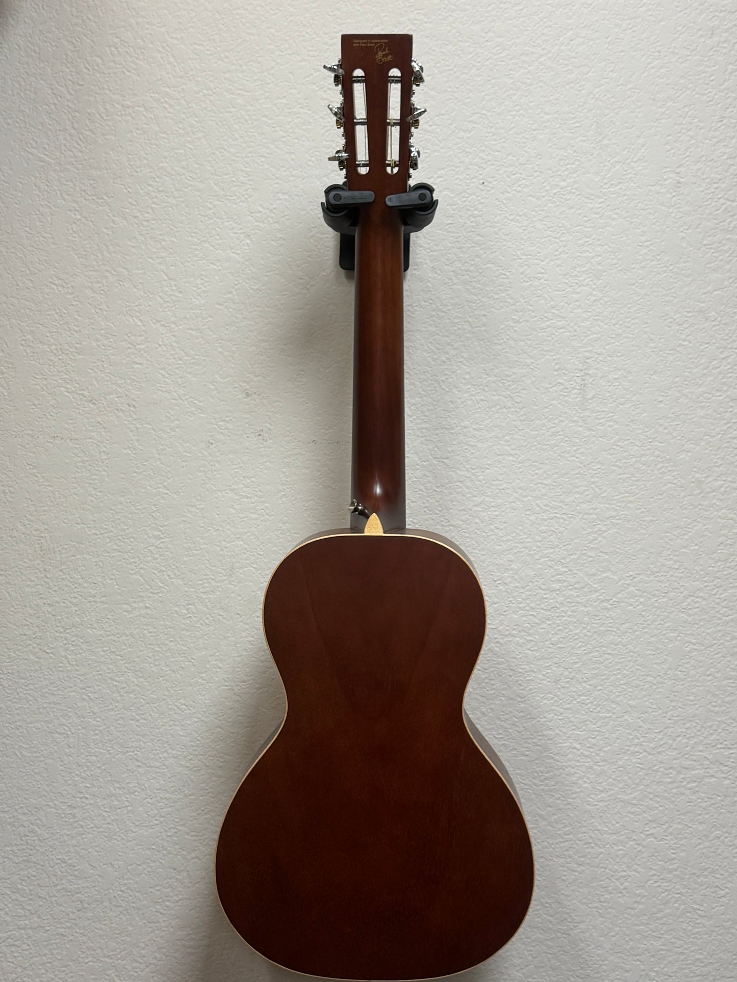 Brown acoustic guitar on a light gray background