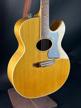 Acoustic guitar with a wooden finish on a dark background