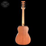 The back view of a wooden acoustic guitar, showing its rich wood grain body and neck, set against a solid black background with a Tone Shop watermark in the top-left corner.