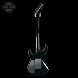 Black electric guitar on a white background with 'Tone Shop' logo.