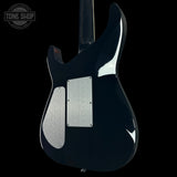 Black electric guitar with a visible brand logo on a black background