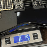 Guitar on a digital scale displaying weight