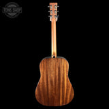 The back of an acoustic guitar with a rich, warm brown wood grain finish, shown against a solid black background with a Tone Shop watermark in the top-left corner.