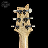 Close-up of a guitar headstock with brand name on a black background