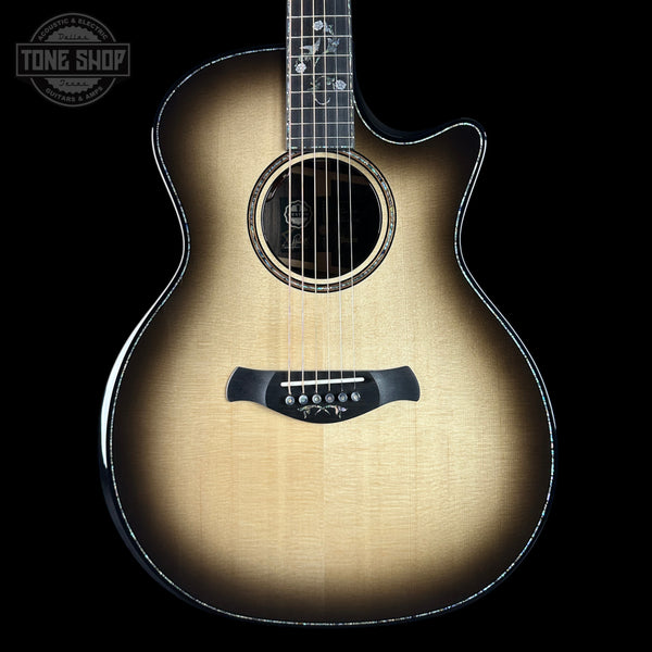 Acoustic guitar with a sunburst finish on a black background, featuring the Tone Shop logo.