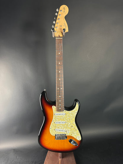 Electric guitar with a sunburst finish on a gray background