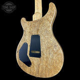 Wooden electric guitar with a black pickguard on a black background, featuring 'Tone Shop' logo.