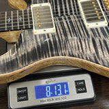 Guitar on a digital scale displaying weight