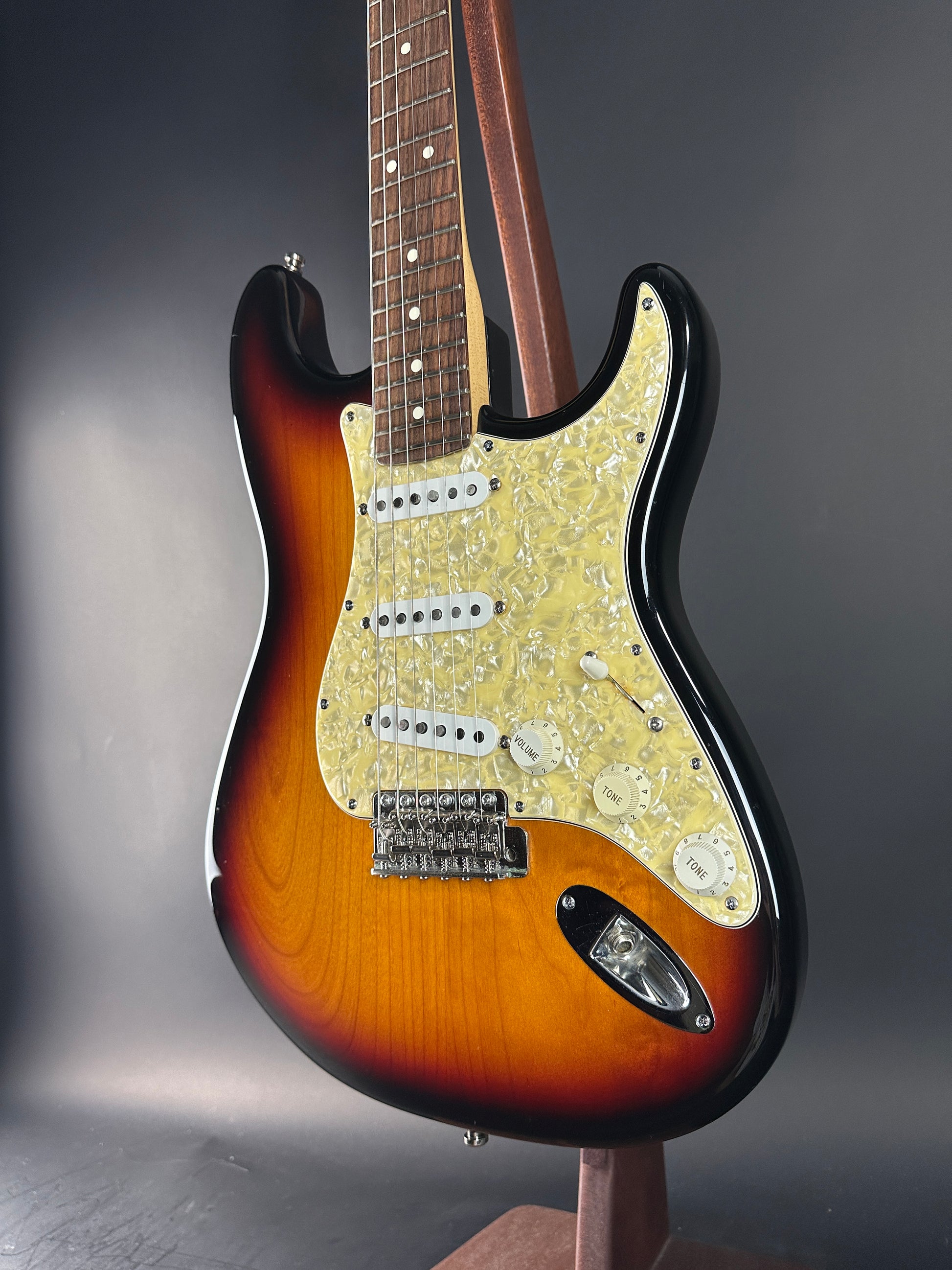 Electric guitar with a sunburst finish on a gray background