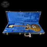 Guitar in a blue case with 'Tone Shop' logo in the corner