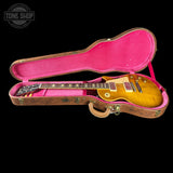 A sunburst electric guitar inside an open hard case with a bright pink velvet interior, photographed against a solid black background. A Tone Shop watermark is visible in the top-left corner.