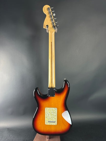Electric guitar with sunburst finish on a gray background