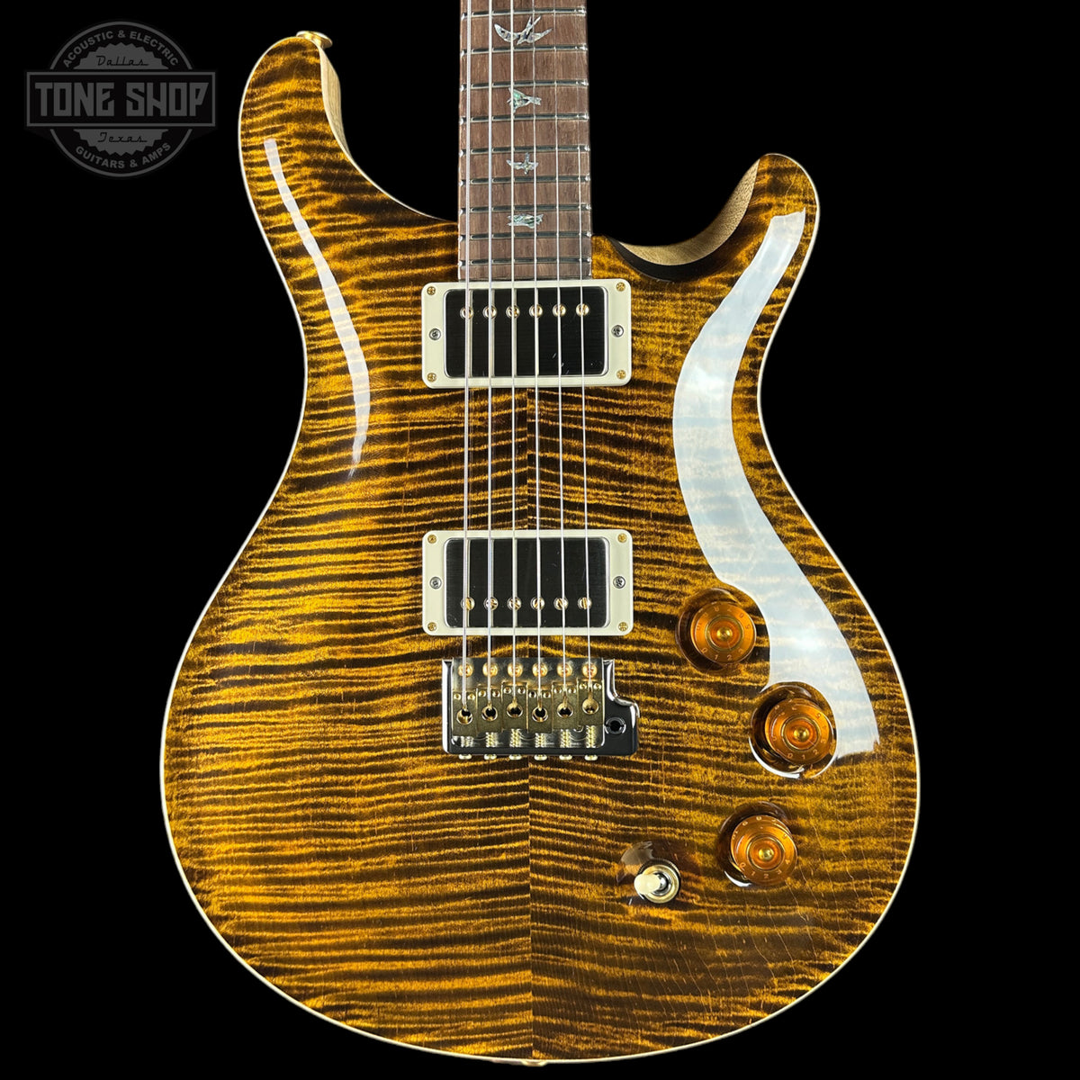 Electric guitar with a wavy wood finish on a black background, featuring the Tone Shop logo.