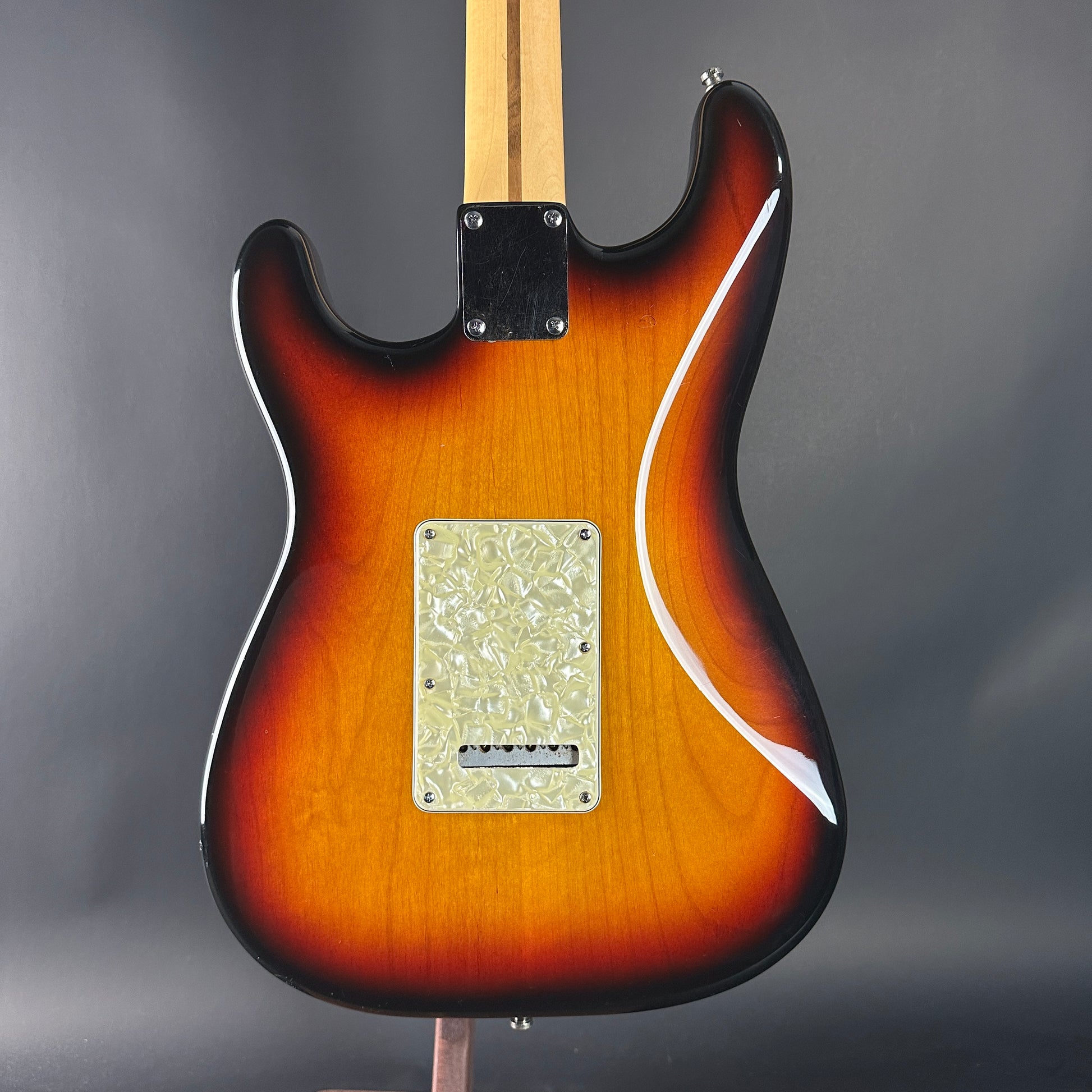 Electric guitar with a sunburst finish on a gray background