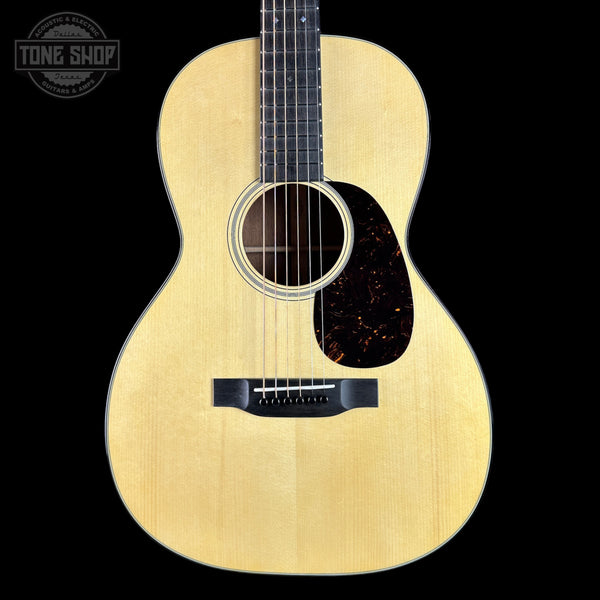 Acoustic guitar with a visible brand logo in the corner